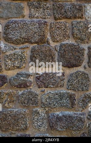 Roman defensive stone wall texture with irregular polygonal blocks built in ancient times. Vertical background with copy space Stock Photo