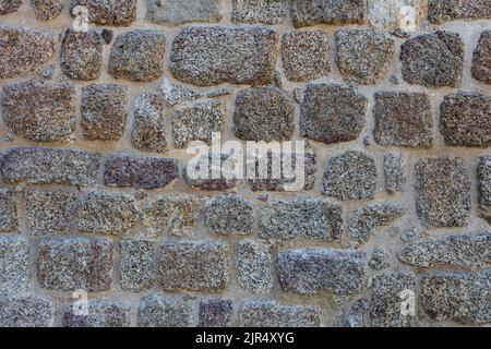 Roman defensive stone wall texture with irregular polygonal blocks built in ancient times. Background with copy space Stock Photo