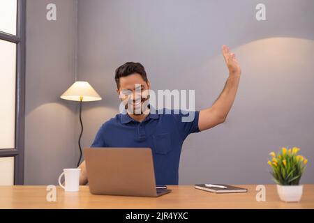 Male freelancer using laptop At Home Office Stock Photo