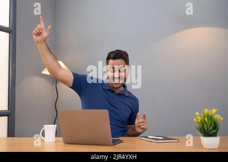 Male freelancer using laptop At Home Office Stock Photo
