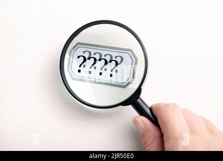 Concept of person seeing double. Person hand holding magnifying glass and looking text and seeing it double and blurred. Stock Photo