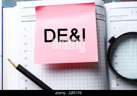 Sticky note with abbreviation DE and I (diversity, equity, inclusion) in diary Stock Photo