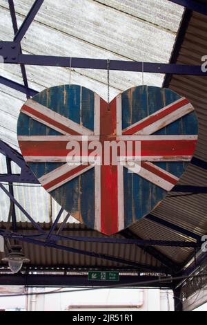 A vertical closeup shot of a heart-shaped union jack sign Stock Photo