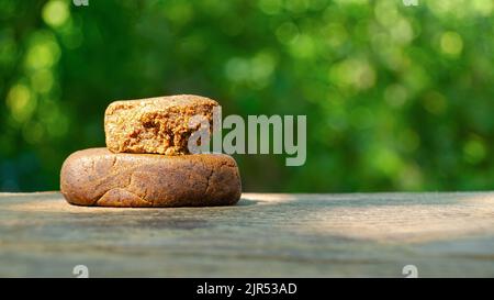 pieces of cannabis hashish with high thc copy space on nature green background. Stock Photo