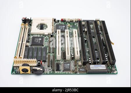 An old mother board of old pc computer isolated in white background Stock Photo