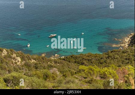 Top view of a portion of the coast facing the island of Serpentara in the south of Sardinia with some rubber boats used by tourists to visit this wond Stock Photo