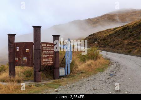 An information sign at the start of Skippers Canyon road in Otago, New Zealand, one of the most dangerous in the country Stock Photo