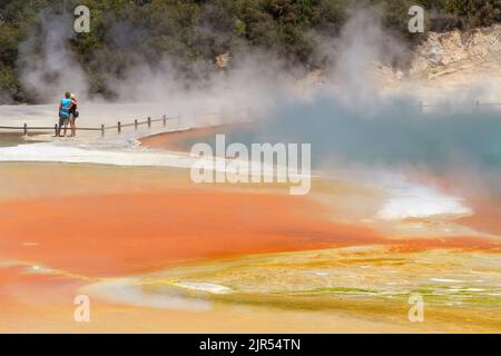 Colorful geothermal pools at Waiotapu Thermal Wonderland, a tourist attraction in New Zealand. To the right is the boiling Champagne Pool Stock Photo