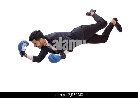 Corporate employee in formal business suit floating in air wearing boxing gloves against white background. Stock Photo