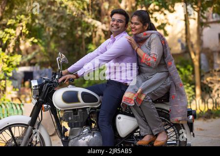 Portrait of happy couple riding on a motorcycle Stock Photo