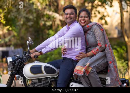 Portrait of happy couple riding on a motorcycle Stock Photo