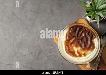 Traditional turkish dessert bakery rice pudding Turkish name Fırın Sutlac in glass bowl Stock Photo