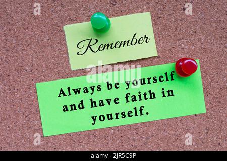 Motivational quote on stick note and pinned to a cork notice board - Remember always be yourself and have faith in yourself. Stock Photo