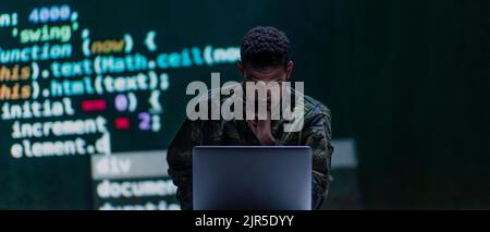 Hacker in military unifrorm on dark web, cyberwar concept. Stock Photo