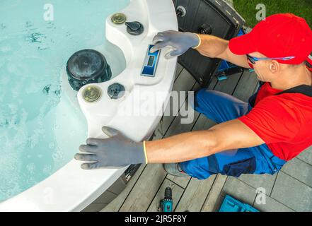Modern Garden Hot Tub Maintenance Performed by Professional SPA Technician Stock Photo