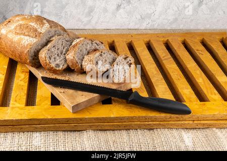 Still life of sliced bread on a wooden surface Stock Photo