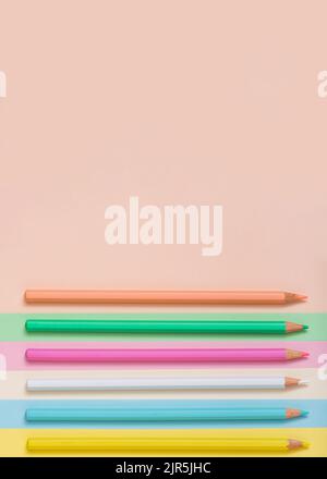 Multicolored pencils lined up on a multicolored background. Abstract minimal concept. Top view, flat lay. Rectangle with copy space Back to school ide Stock Photo