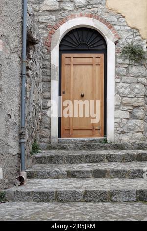 steps to the wooden door in a old street of Caccamo in Sicily, Italy Stock Photo