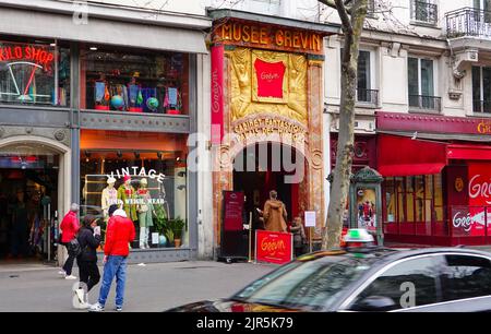 People entering the baroque front of the Musée Grévin wax museum, one of the oldest wax museums in Europe, Grands Boulevards, Paris, France. Stock Photo