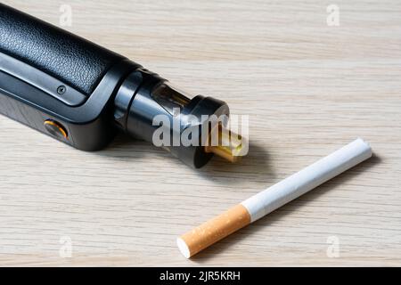 Quit smoking with electronic cigarettes. Electronic cigarette and cigarette. Stock Photo