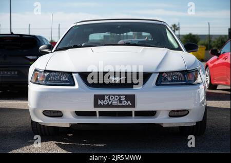 A clean white Ford Mustang GT convertible parked on a street Stock Photo