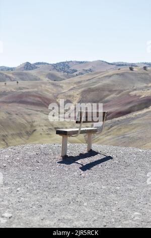 An empty bench facing the Painted Hills in Oregon, USA. Stock Photo