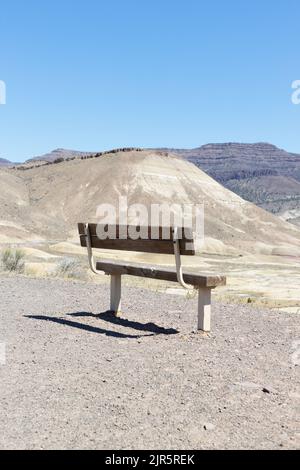 An empty bench facing the Painted Hills in Oregon, USA. Stock Photo