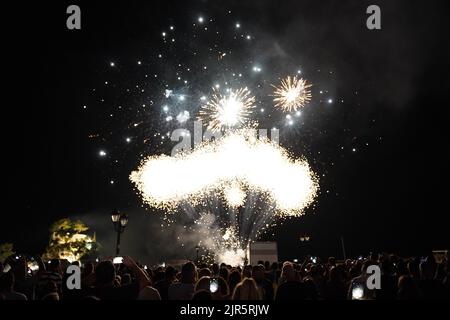 parga Greece, crowd of tourists enjoying fireworks show on night sky at celebration of 15 august 2022 in parga town in greece, epirus Stock Photo