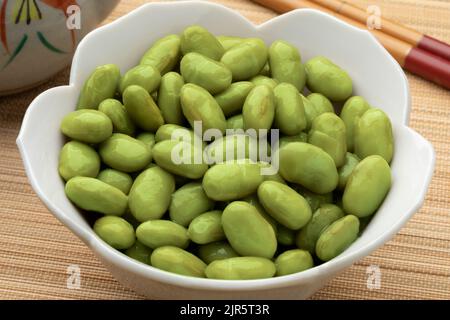 Bowl with preserved healthy green edamame beans close up Stock Photo