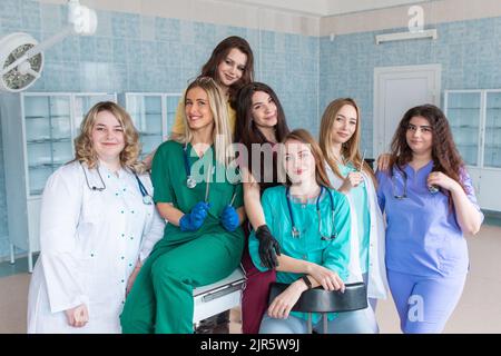 Medical students smile at the camera in the surgery room. The concept of healthcare and medicine. Stock Photo