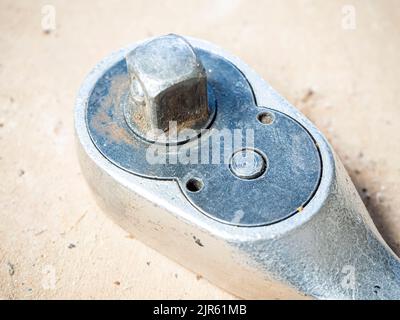 antique ratchet wrench on an antique wooden base. Stock Photo