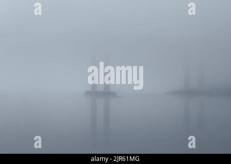 Under one of the many bridges over Douro river in a foggy dawn Stock Photo