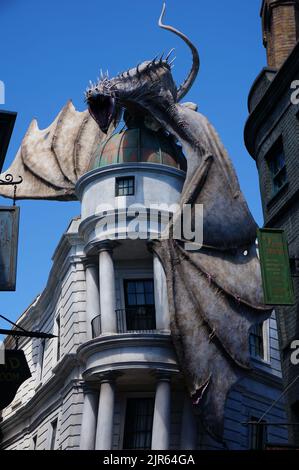 A vertical shot of a Harry Potter theme building with a big dragon on top in Universal Studios Stock Photo