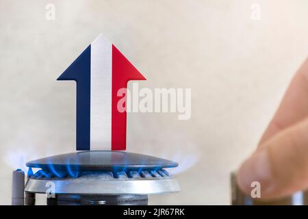 Gas price. Rise in gas prices in France. A burner with a flame and an arrow up, painted in the colors of the France flag. The concept of rising gas or Stock Photo
