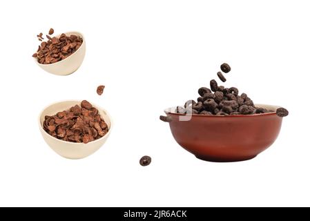 Chocolate rings cereal spill out into a bowl. Breakfast. Isolated on a white background. Stock Photo