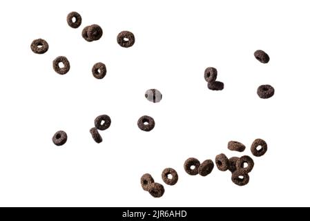 Chocolate rings cereal spill out into a bowl. Breakfast. Isolated on a white background. Stock Photo