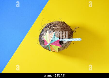 A coconut drink isolated on a blue and yellow background Stock Photo