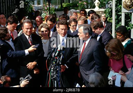 Mississippi Attorney General Mike Moore, center, and lead negotiator in the  lawsuit between the states and the tobacco industry holds his hands up to  calm the press as he announces a tentative