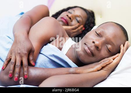 A tired beautiful young loving couples sleep deeply together in their bed Stock Photo