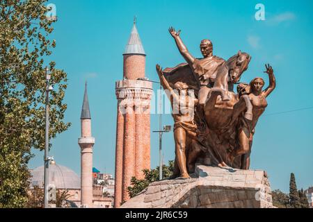 07 July 2022, Antalya, Turkey: Mustafa Kemal Ataturk equestrian statue on a square in Antalya. Yivli minaret and Old town in the background Stock Photo