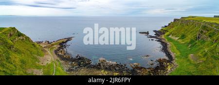 Panorama of Atlantic coastline in Northern Ireland with Giant’s Causeway, unique natural geological formations of volcanic basalt rocks, resembling co Stock Photo