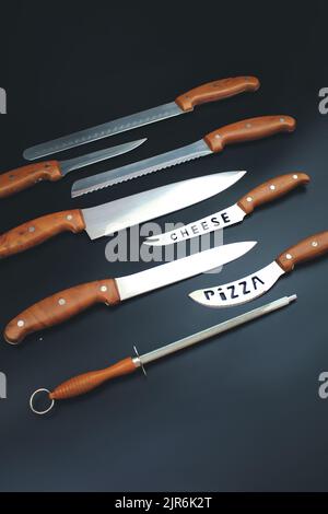 Set of Kitchen knives on grey background. Quality Kitchen Knives. Stock Photo