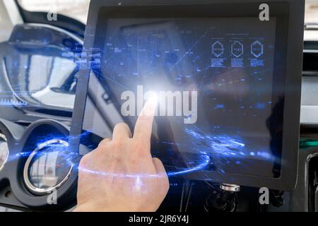 An autonomous vehicle interior with hand touching screen and auto navigation system Stock Photo