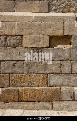 Old Damaged Stone Block Wall captured located in El Moez Street - Old Cairo - Egypt Stock Photo