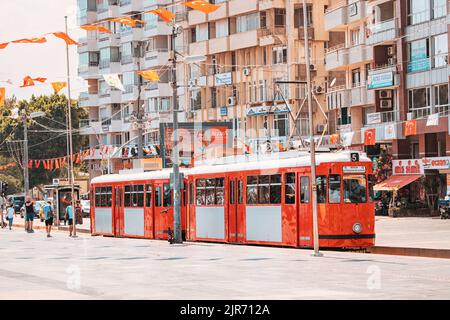 07 July 2022, Antalya, Turkey: Retro vintage tram line for tourists and locals leading to old town centre. Stock Photo