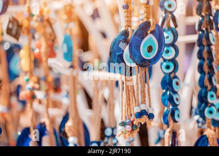 Evil eye turkish bead amulets hanging in souvenir store. Gift and superstitions concept Stock Photo