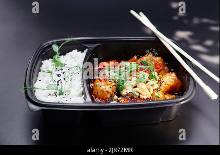 Delicious asian wok with rice, chicken and vegetables. Thai traditional street food: fresh stir fried chicken with vegetables, served with jasmine rice on the side. High quality photo Stock Photo