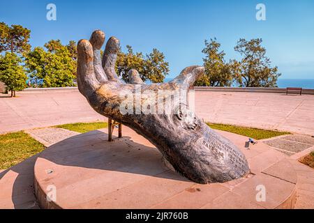 09 July 2022, Antalya, Turkey: Hand with Mustafa Kemal Ataturk carvings on a square in Karaalioglu park Stock Photo