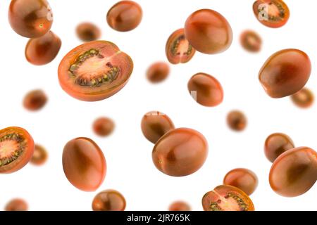 Falling kumato black tomato, cherry, isolated on white background, selective focus Stock Photo