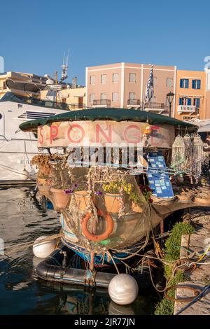 chania, crete, floating shop, floating souvenir shop in chania harbour on the island of crete selling natural sponges and sea shells to tourists. Stock Photo